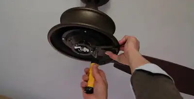 Electrician installing ceiling fan mounting bracket and fixture in Reno, NV