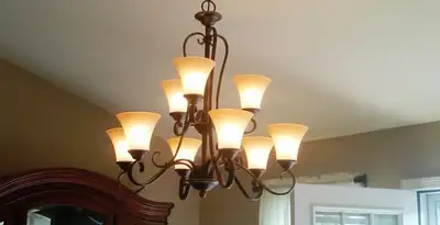 Classic ceiling chandelier installation with warm lighting in Reno, NV
