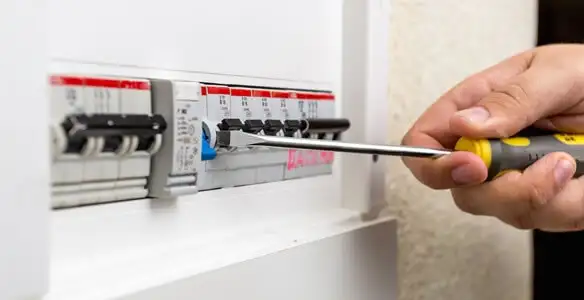electrical panel upgrade service showing technician adjusting circuit breakers during system upgrade in Reno, NV