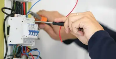 Electrician installing and adjusting circuit breakers in an electrical panel in Reno, NV