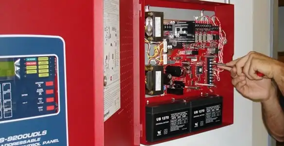 fire alarm installation service showing technician configuring fire alarm control panel in Reno, NV