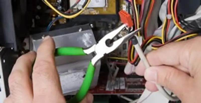 Licensed electrical contractor performing electrical repair with tools in Sun Valley, NV