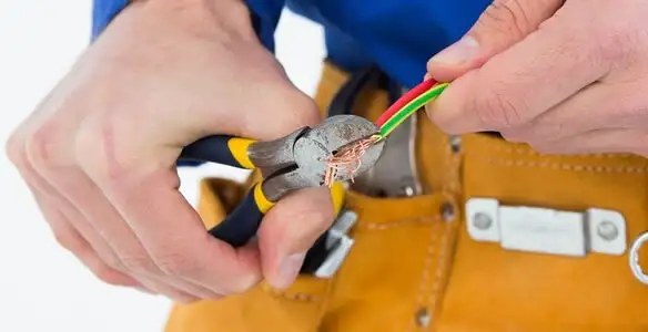 licensed electrician securing electrical wiring with professional tools during service work in Reno, NV